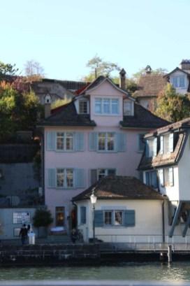 A photo of guild houses in Zurich brown blue and pink architecture from the 1336